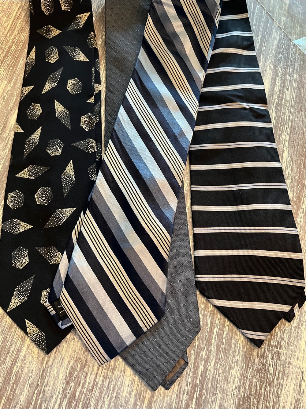 Set of 4 Assorted brands and patterns of men’s ties. New in pkgs. Greys & Blacks